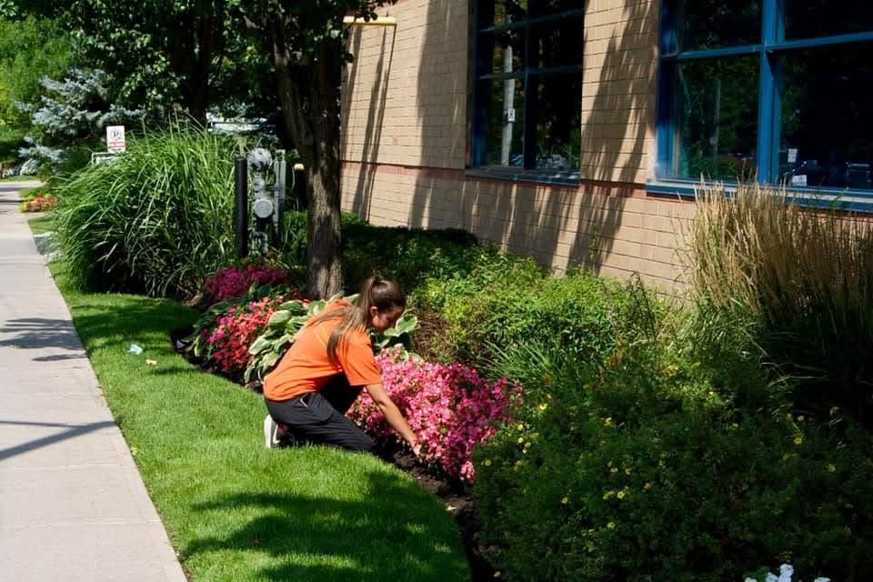 KJS crew member tending garden beds at commercial property