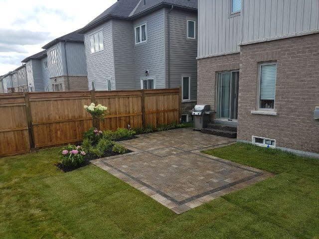 Finished paver patio installation in townhome backyard